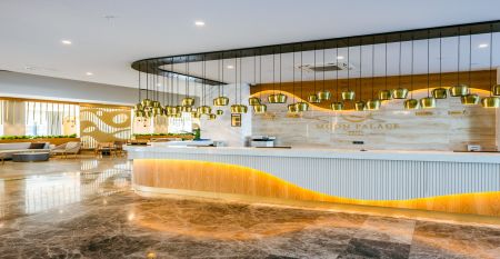 Das Side Moon Palace ist ein modernes Hotel mit mehreren Etagen und Balkonen, von denen aus man den Blick auf einen gro&szlig;z&uuml;gigen Au&szlig;enpool genie&szlig;en kann, der von Reihen wei&szlig;er Liegest&uuml;hle und geschlossenen Sonnenschirmen ges&auml;umt ist.