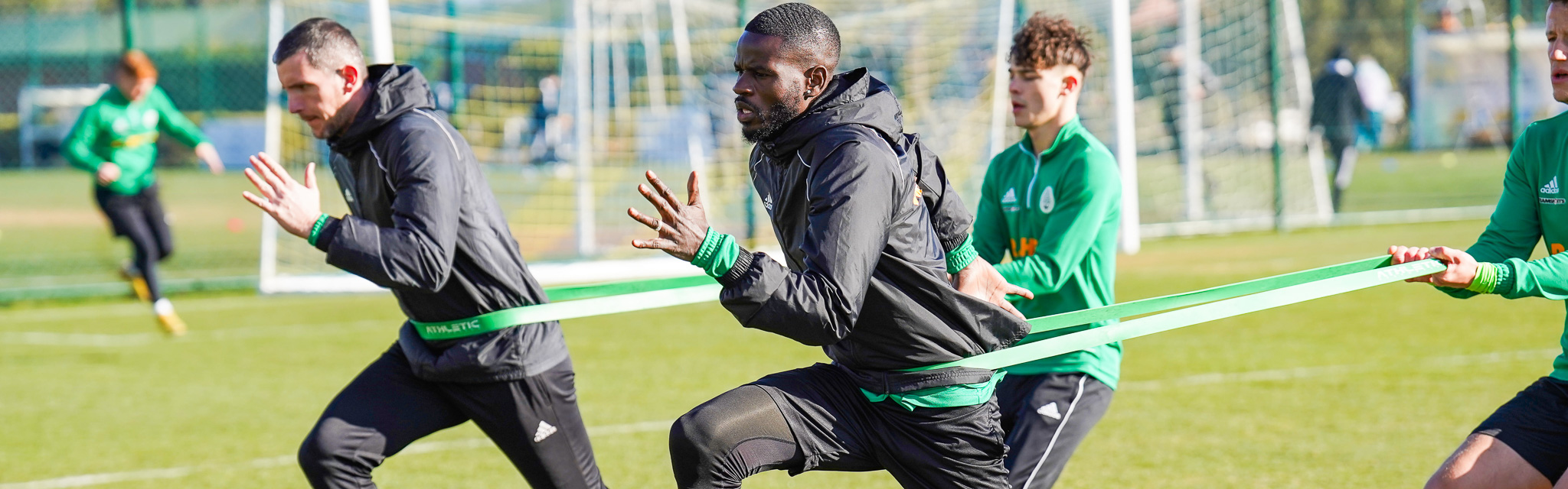 Fußballspieler und ein Fußball auf gepflegten Rasen.