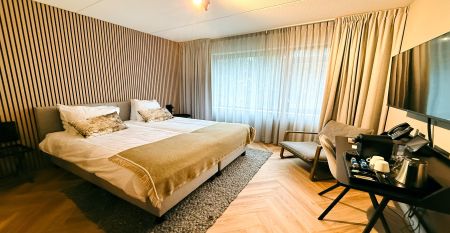 Hotel De Beyaerd&rsquo;s bright, modern restaurant features large glass walls, light wood floors, and stylish gray and yellow chairs&mdash;an ideal setting for teambuilding activities surrounded by lush greenery.