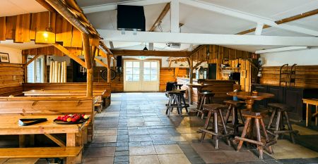 Hotel De Beyaerd&rsquo;s bright, modern restaurant features large glass walls, light wood floors, and stylish gray and yellow chairs&mdash;an ideal setting for teambuilding activities surrounded by lush greenery.