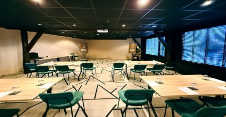 Hotel De Beyaerd&rsquo;s bright, modern restaurant features large glass walls, light wood floors, and stylish gray and yellow chairs&mdash;an ideal setting for teambuilding activities surrounded by lush greenery.