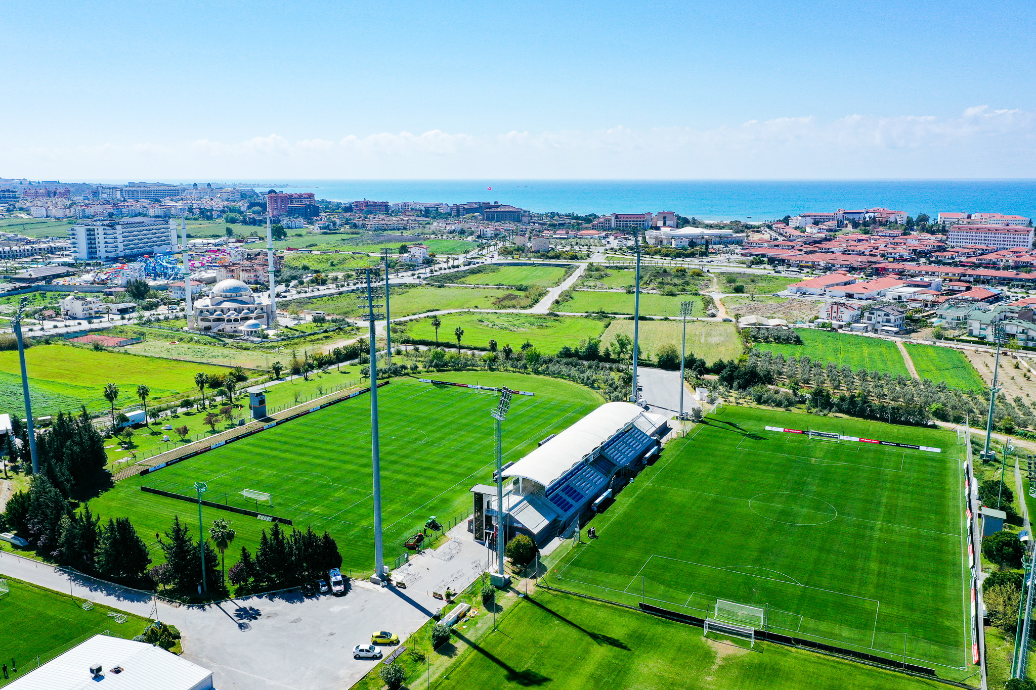 Football training camp in Turkey with two well-maintained football pitches, surrounded by green countryside and close to the coast.